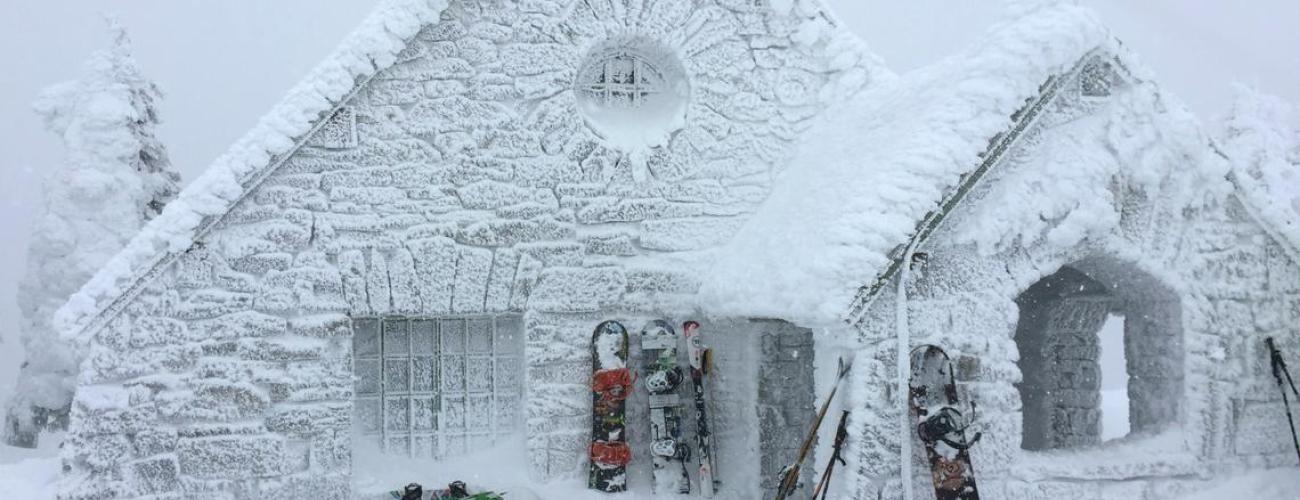 Vista House covered in snow with snowboards