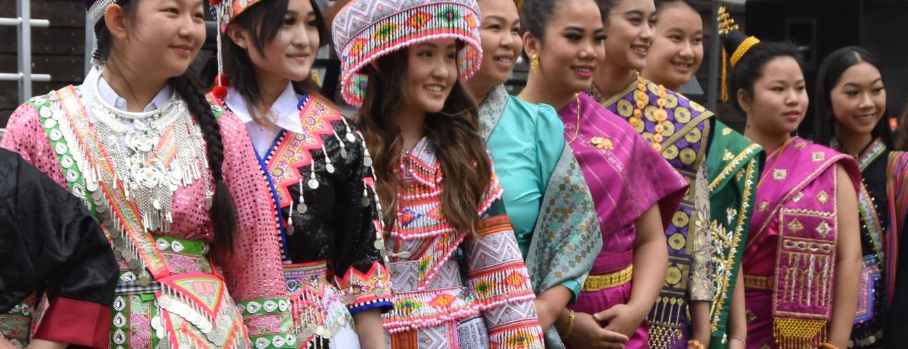 A group of Laotian, Hmong and Khmu women pose in traditional dress.