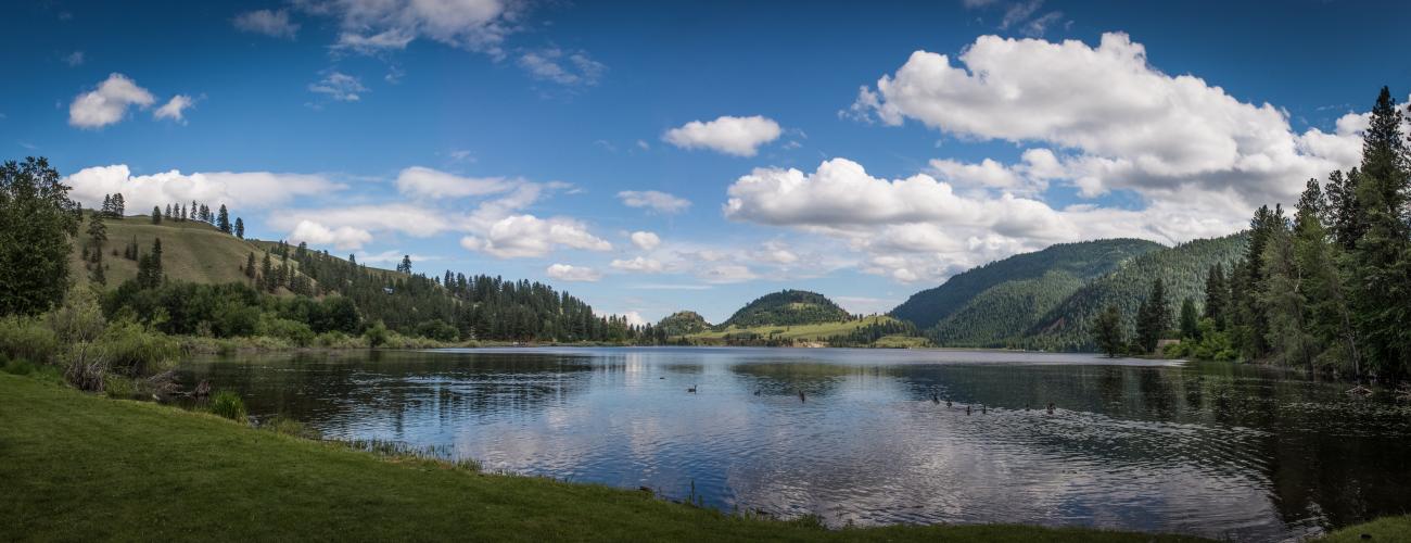 blue lake surrounded by trees and mountains