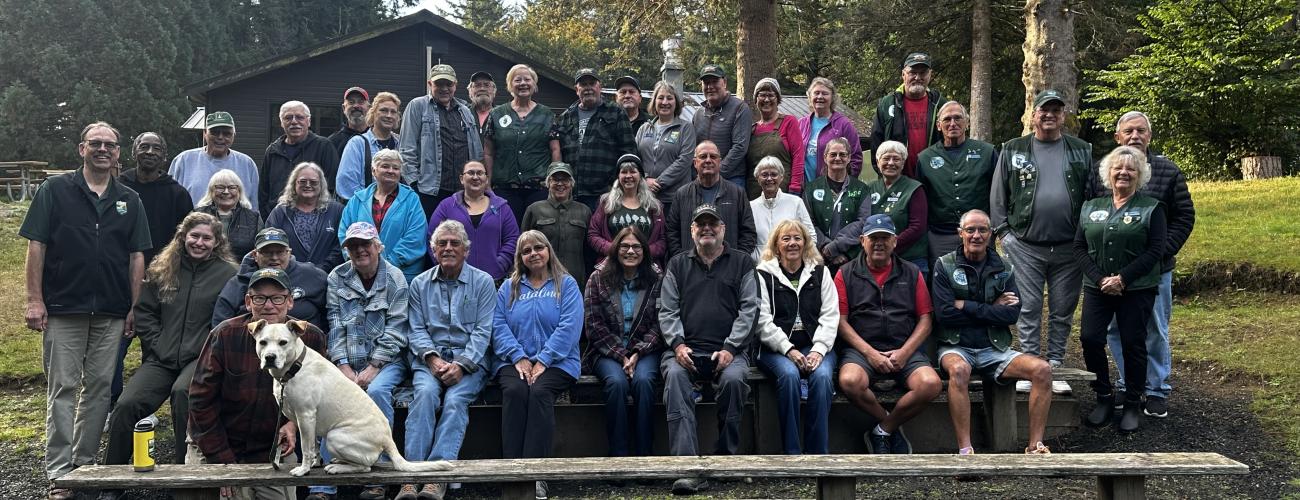 Group photo of volunteers on bleachers at 2024 Host Camporee