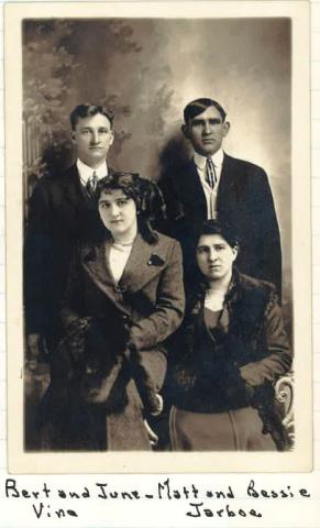 A sepia toned portrait of two couples in formal dress.