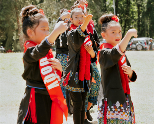 Three Iu Mien children walk in a community parade.