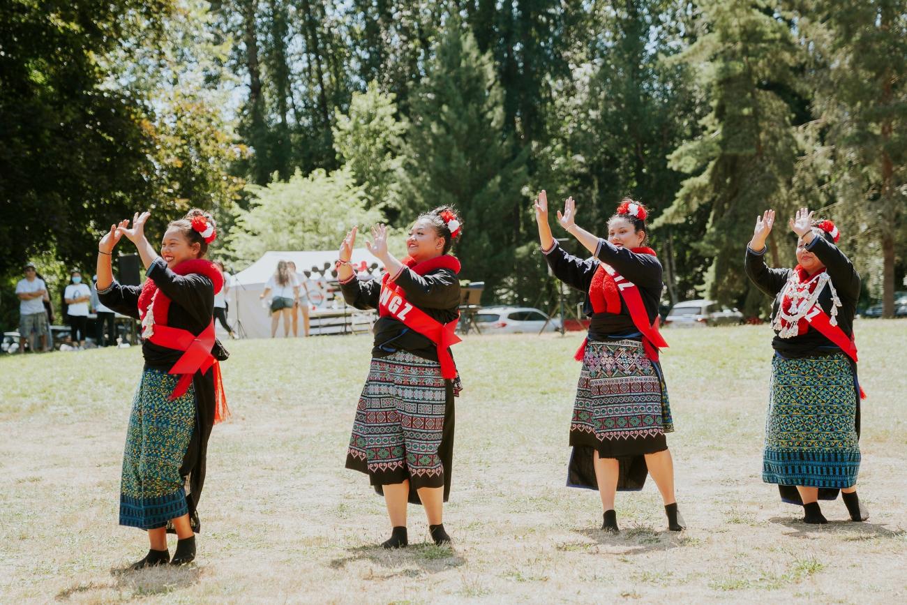 lu Mien dancers in traditional cloths dance is a grassy field