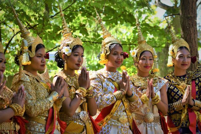 A group of Cambodian women in traditional dress prepare for a dance performance.