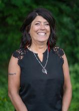 Washington State Parks Tribal Relations Director Jenna Bowman poses in front of evergreen trees.