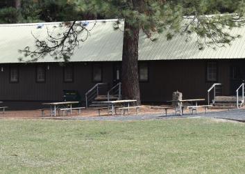 Long wooden building with picnic tables