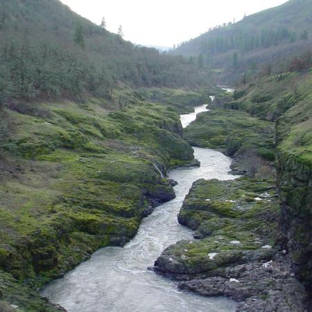 A narrow river runs through a rocky canyon.