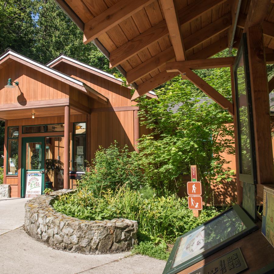 View of the contact station from the outside. Th entrance to the contact station is visible as well as some of the interpretive boards featured outside of the entrance. 