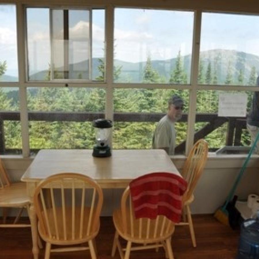 Quartz Mountain Fire Lookout Interior with dining table and outside view