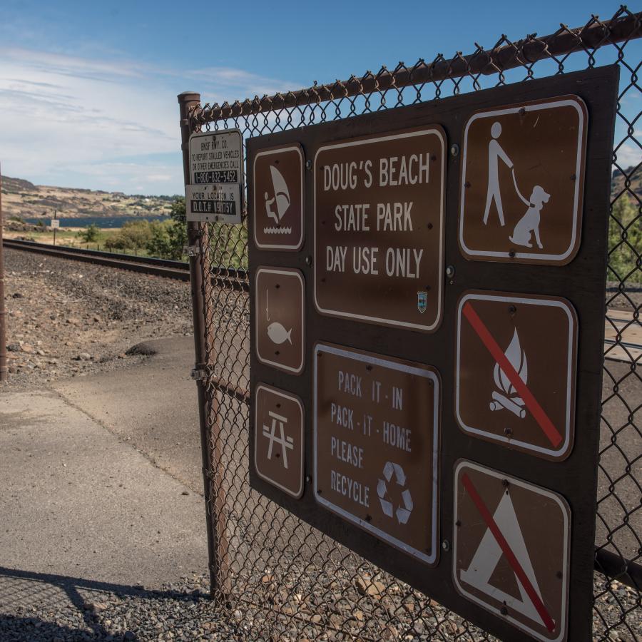 Day use signage showing rules and gate