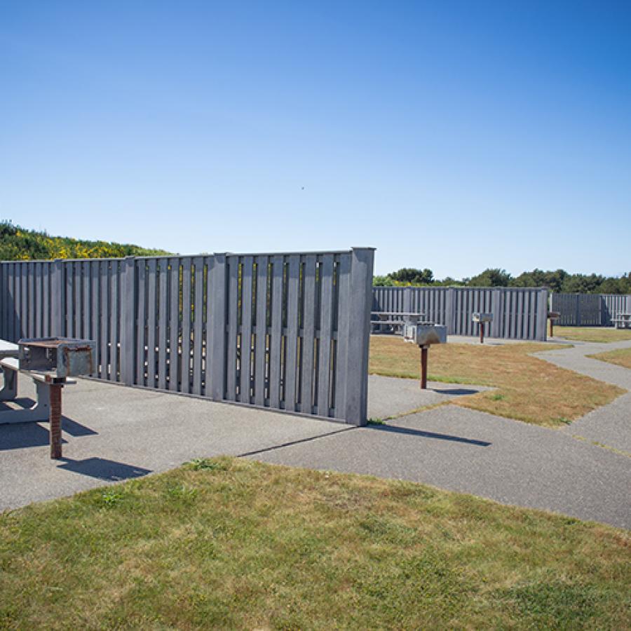 Picnic tables with a privacy fence at Westport Lighthouse State Park. 