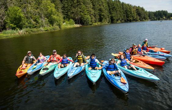 youth participants in a paddle safety course posing for a group photo