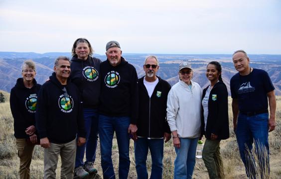 Photo of Commissioners at Puffer Butte in Spring Fields State Park. Left to right Commissioner Holly Williams, Commissioner Ali Raad, Director Diana Dupuis, Commissioner Ken Bounds, Commissioner Laurie Connelly, Commissioner Sophia Danenberg, Commissioner Michael Latimer.